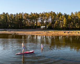 Paddleboarding at Versso ÖÖD Hotels in Finland at the Bay