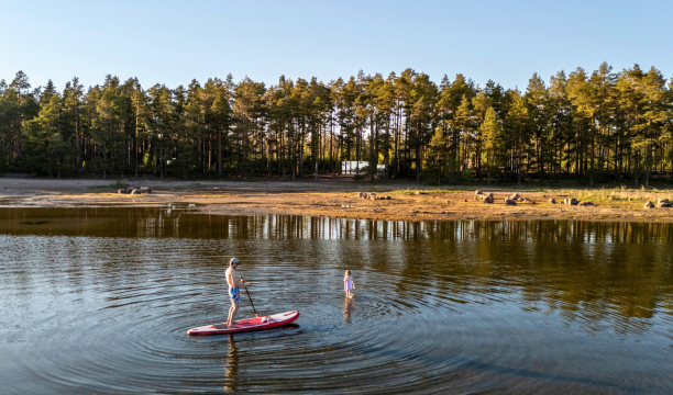 Paddleboarding at Versso ÖÖD Hotels in Finland at the Bay